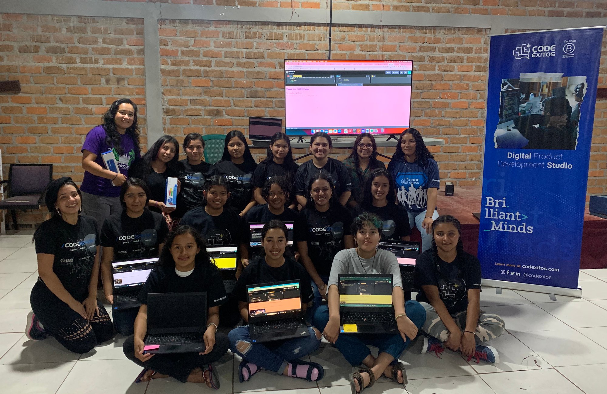 group of girls with laptops in a workshop about coding