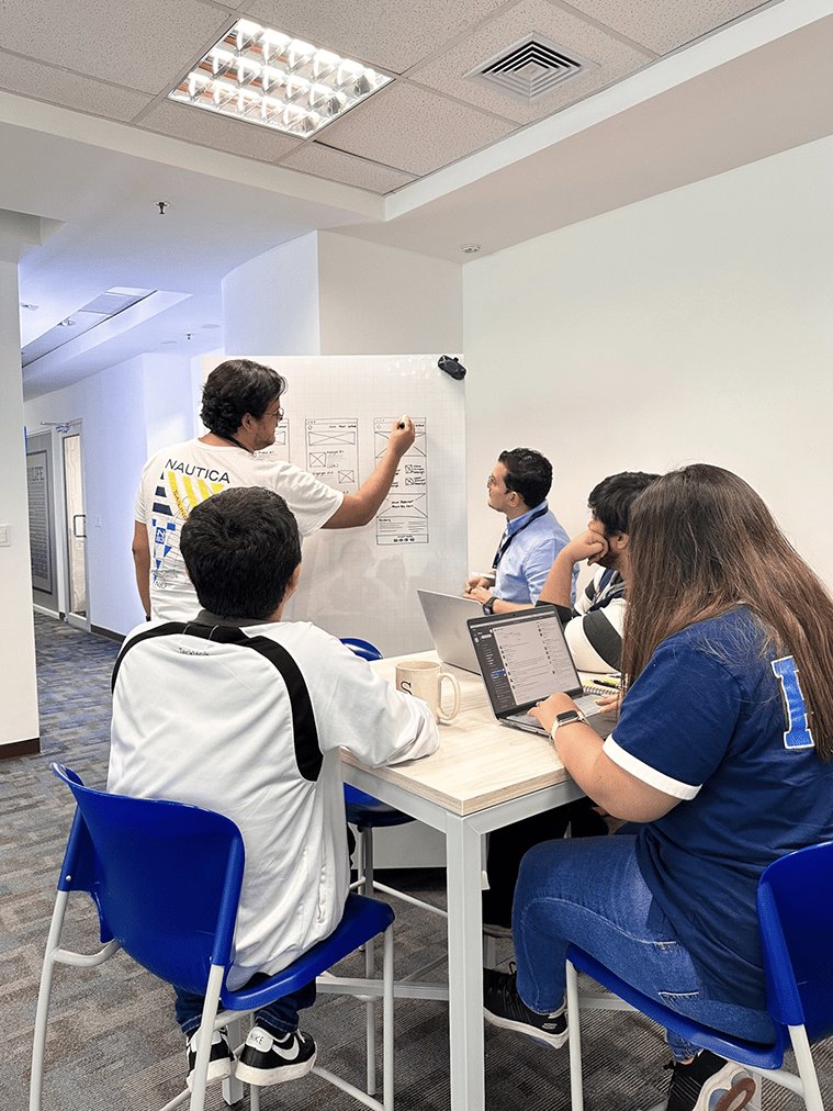 coworkers sitting on tall table working on wireframes