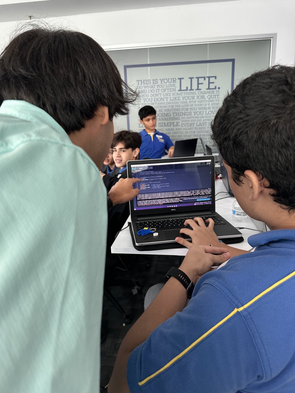 student and mentor working on a computer